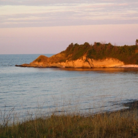 към края