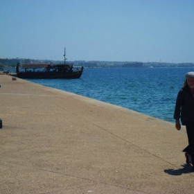 Walking stranger by the sea deck